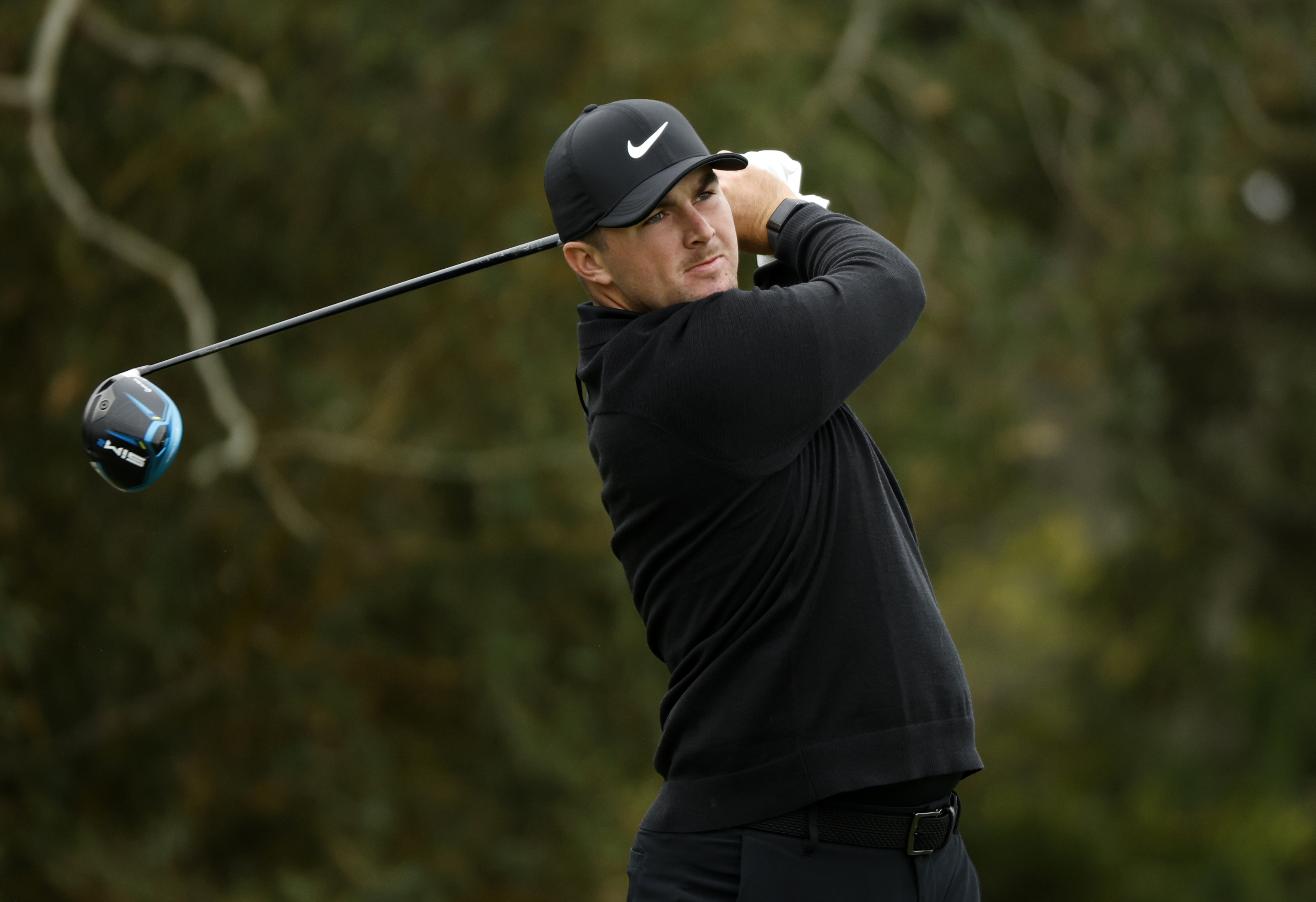Golfer taking a swing.